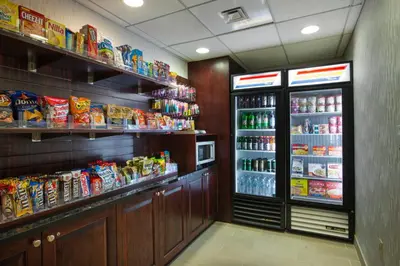 a grocery store with a refrigerator and lots of food at Holiday Inn Express Hotel & Suites Philadelphia - King of Prussia by IHG in King of Prussia