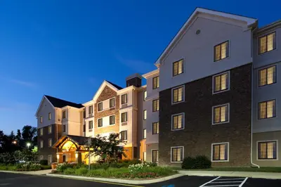 a row of apartment buildings at night at Staybridge Suites Wilmington-Newark by IHG in Newark