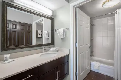 a bathroom with a sink and a mirror at Staybridge Suites Wilmington-Newark by IHG in Newark