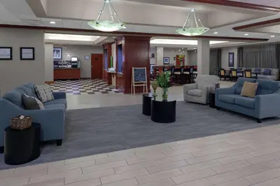 a lobby with couches and chairs in a building at Hampton Inn Woodbridge in Woodbridge