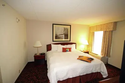 a hotel room with a bed with a tray on it at Hampton Inn Woodbridge in Woodbridge