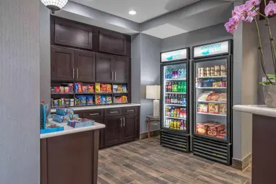 a grocery store with two refrigerators and a counter at Homewood Suites by Hilton Philadelphia Plymouth Meeting in Plymouth Meeting