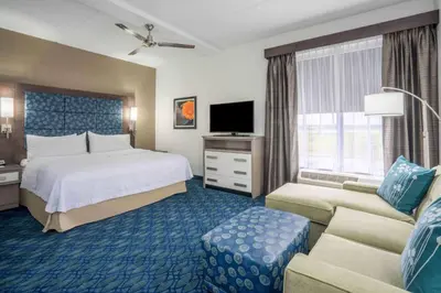 a hotel room with a bed and a couch at Homewood Suites by Hilton Philadelphia Plymouth Meeting in Plymouth Meeting
