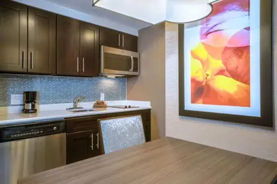 a kitchen with a table and a painting on the wall at Homewood Suites by Hilton Philadelphia Plymouth Meeting in Plymouth Meeting