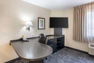 a hotel room with a desk and a tv at Executive Residency by Best Western Philadelphia-Willow Grove in Horsham