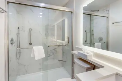 a white bathroom with a shower and a sink at Executive Residency by Best Western Philadelphia-Willow Grove in Horsham