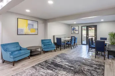 a waiting room with blue chairs and a table at Executive Residency by Best Western Philadelphia-Willow Grove in Horsham