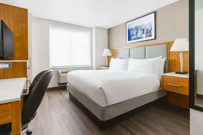 a hotel room with a large bed and a television at DoubleTree by Hilton Hotel New York City - Chelsea in New York
