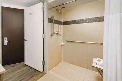 a bathroom with a shower with a glass door at DoubleTree by Hilton Hotel New York City - Chelsea in New York