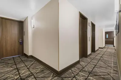 a hallway with a row of elevators in a building at DoubleTree by Hilton Hotel New York City - Chelsea in New York