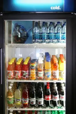 a refrigerator filled with lots of bottles of soda at Hampton Inn & Suites Bethlehem in Bethlehem