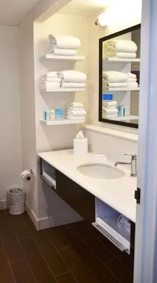 a bathroom with a sink and a mirror and towels at Hampton Inn & Suites Bethlehem in Bethlehem