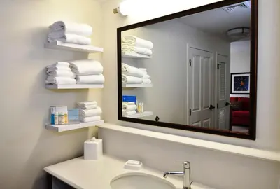 a bathroom with a sink and a mirror and towels at Hampton Inn & Suites Bethlehem in Bethlehem