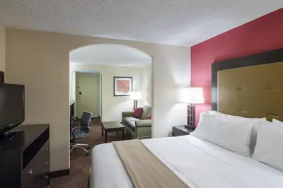 a hotel room with a bed and a living room at Holiday Inn Express Frazer - Malvern by IHG in Frazer