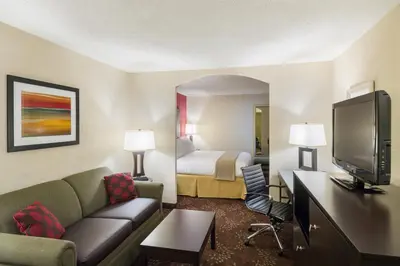 a hotel room with a couch and a bed at Holiday Inn Express Frazer - Malvern by IHG in Frazer