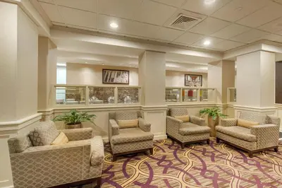a waiting room with chairs and a waiting area with plants at DoubleTree by Hilton Downtown Wilmington - Legal District in Wilmington