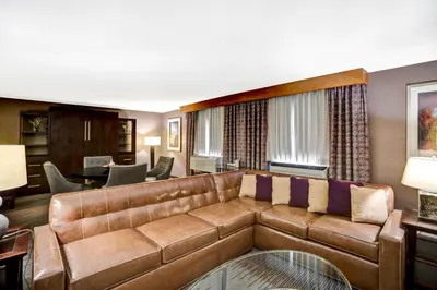 a living room with a couch and a table at DoubleTree by Hilton Downtown Wilmington - Legal District in Wilmington