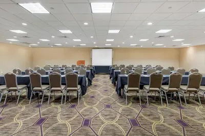 a conference room with rows of chairs and a whiteboard at DoubleTree by Hilton Downtown Wilmington - Legal District in Wilmington