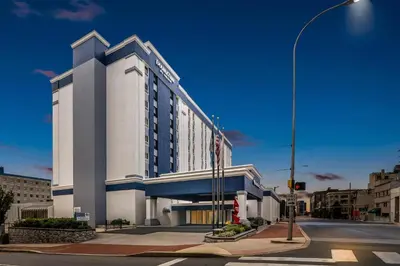 a large white building on a city street with a street light at DoubleTree by Hilton Downtown Wilmington - Legal District in Wilmington