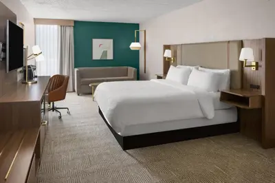 a hotel room with a large bed and a desk at Holiday Inn Morgantown - Reading Area by IHG in Morgantown