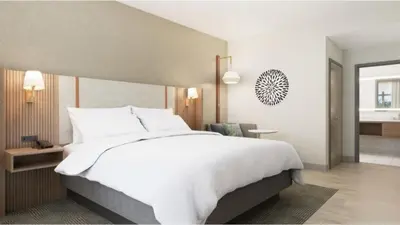 a large white bed in a hotel room at Holiday Inn Morgantown - Reading Area by IHG in Morgantown