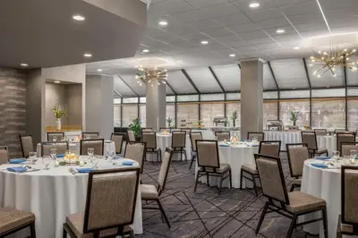 a banquet hall with white tables and chairs at Crowne Plaza Edison by IHG in Edison