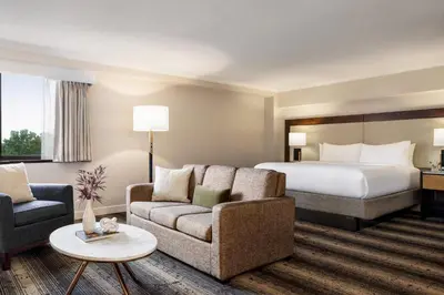 a hotel room with a bed and a couch at Crowne Plaza Edison by IHG in Edison