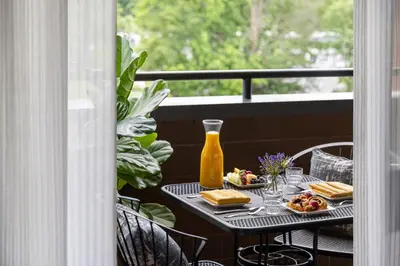 a table with plates of food on a balcony at Crowne Plaza Edison by IHG in Edison