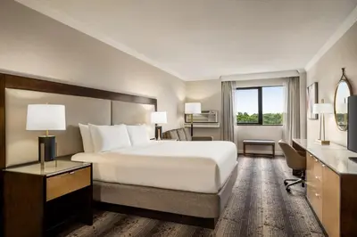 a hotel room with a bed and a window at Crowne Plaza Edison by IHG in Edison