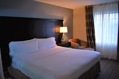 a hotel room with a large bed and a window at Staybridge Suites Cranbury - South Brunswick by IHG in Cranbury