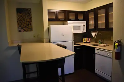a kitchen with a white refrigerator and a counter top at Staybridge Suites Cranbury - South Brunswick by IHG in Cranbury