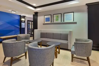a waiting room with a couch and chairs at Holiday Inn Express Hotel & Suites Warminster-Horsham by IHG in Warminster