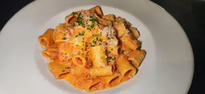 a plate of pasta on a white plate at Crowne Plaza Englewood by IHG in Englewood