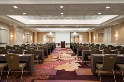 a conference room with tables and chairs and a podium at Crowne Plaza Englewood by IHG in Englewood