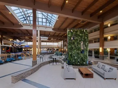 a large lobby with couches and tables in a building at Crowne Plaza Suffern-Mahwah by IHG in Suffern