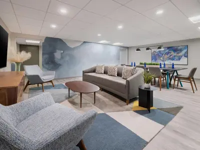 a lobby with a couch and chairs and a table at Crowne Plaza Suffern-Mahwah by IHG in Suffern