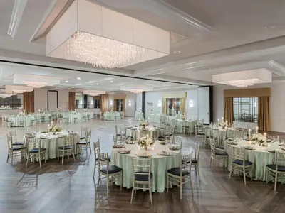 a banquet hall with round tables and chairs at Crowne Plaza Suffern-Mahwah by IHG in Suffern