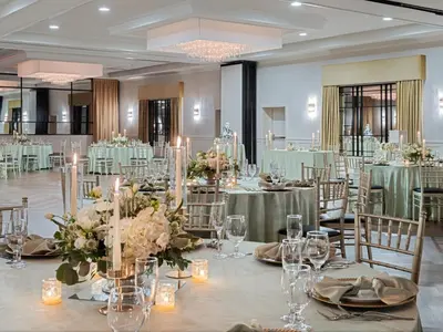 a ballroom with tables and chairs with flowers and candles at Crowne Plaza Suffern-Mahwah by IHG in Suffern