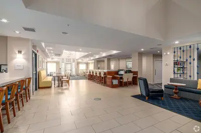a lobby of a hospital with chairs and a bar at Avia Residences on Lincoln - Extended Stay in Malvern
