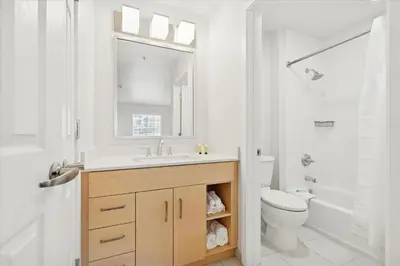 a white bathroom with a sink and a toilet at Avia Residences on Lincoln - Extended Stay in Malvern