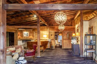 a living room with wooden ceilings and a chandelier at The Inn at Leola Village, a Historic Hotel of America in Lancaster