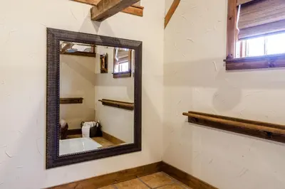 a mirror in a bathroom with a bath tub at The Inn at Leola Village, a Historic Hotel of America in Lancaster