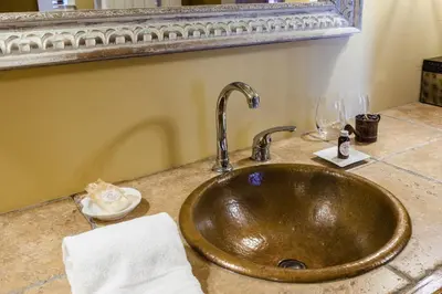 a copper sink in a bathroom with a mirror at The Inn at Leola Village, a Historic Hotel of America in Lancaster