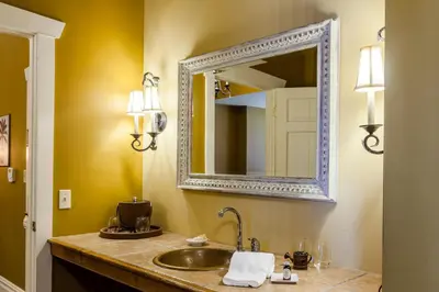 a bathroom with a sink and a mirror at The Inn at Leola Village, a Historic Hotel of America in Lancaster