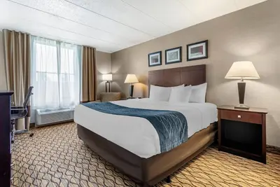 a hotel room with a large bed and a window at Comfort Inn & Suites Glen Mills - West Chester in Glen Mills
