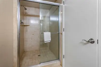 a shower with a glass door with a towel at Comfort Inn & Suites Glen Mills - West Chester in Glen Mills