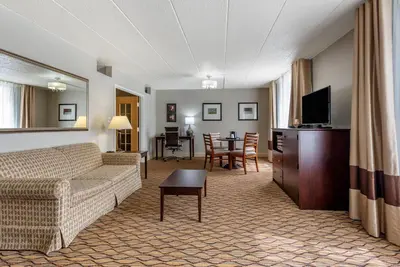a living room with a couch and a tv and a table at Comfort Inn & Suites Glen Mills - West Chester in Glen Mills