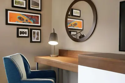 a room with a mirror and a desk and a chair at Hampton Inn & Suites Ephrata - Mountain Springs in Ephrata