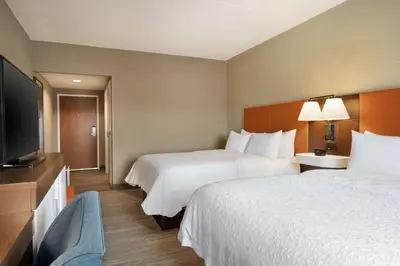 a hotel room with two beds and a flat screen tv at Hampton Inn & Suites Ephrata - Mountain Springs in Ephrata
