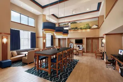 a large living room with a table and chairs at Hampton Inn & Suites Ephrata - Mountain Springs in Ephrata